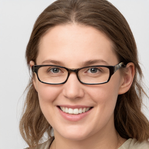 Joyful white young-adult female with medium  brown hair and blue eyes