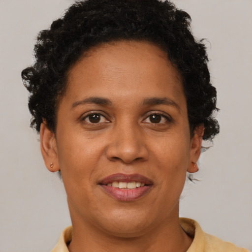Joyful black adult female with short  brown hair and brown eyes