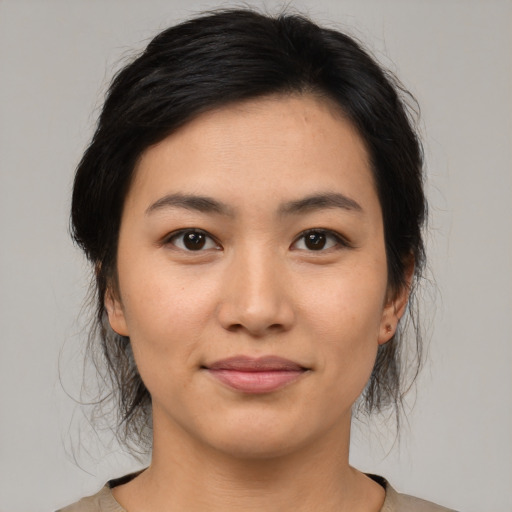 Joyful latino young-adult female with medium  brown hair and brown eyes