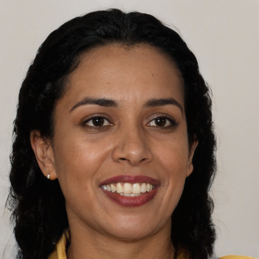 Joyful latino young-adult female with long  black hair and brown eyes