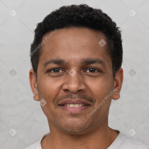 Joyful latino young-adult male with short  brown hair and brown eyes