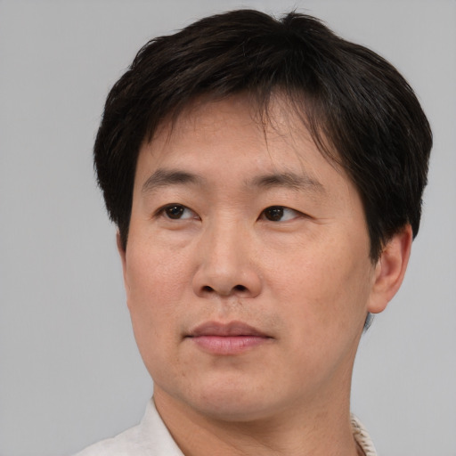 Neutral asian adult male with short  brown hair and brown eyes
