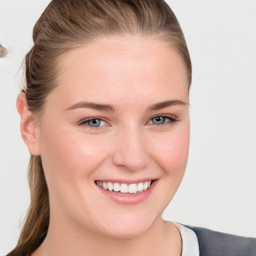 Joyful white young-adult female with long  brown hair and blue eyes