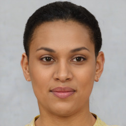 Joyful latino young-adult female with short  brown hair and brown eyes