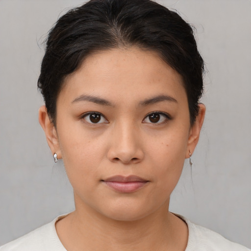 Joyful asian young-adult female with short  brown hair and brown eyes