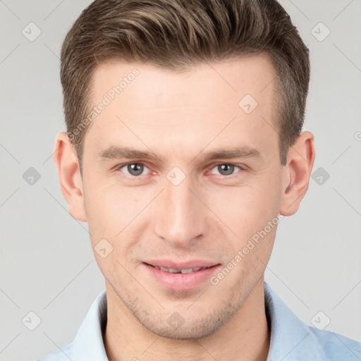 Joyful white young-adult male with short  brown hair and grey eyes