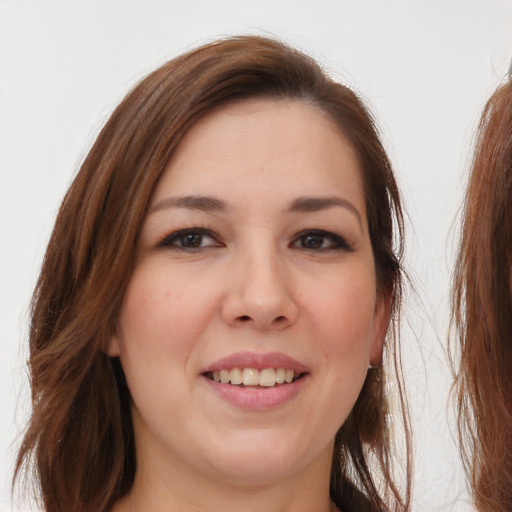 Joyful white young-adult female with long  brown hair and brown eyes