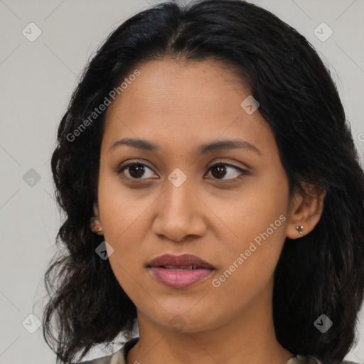 Joyful latino young-adult female with long  black hair and brown eyes