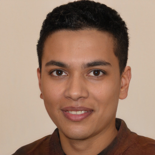 Joyful latino young-adult male with short  black hair and brown eyes