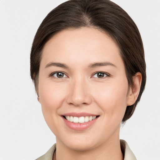 Joyful white young-adult female with medium  brown hair and brown eyes