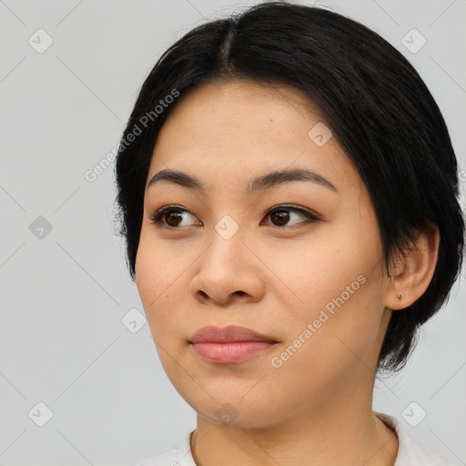 Joyful asian young-adult female with medium  black hair and brown eyes