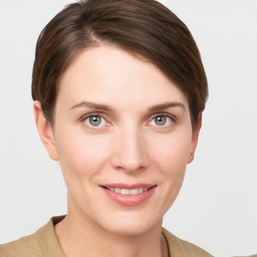 Joyful white young-adult female with short  brown hair and grey eyes