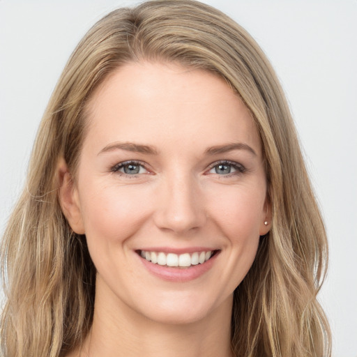 Joyful white young-adult female with long  brown hair and blue eyes