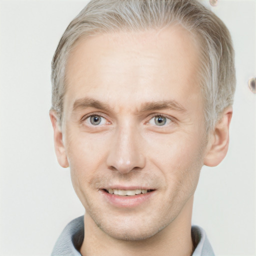 Joyful white adult male with short  brown hair and grey eyes