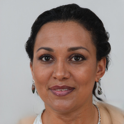 Joyful black adult female with short  brown hair and brown eyes