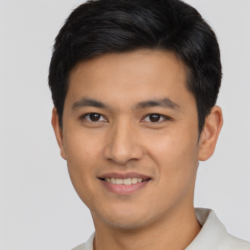 Joyful asian young-adult male with short  brown hair and brown eyes