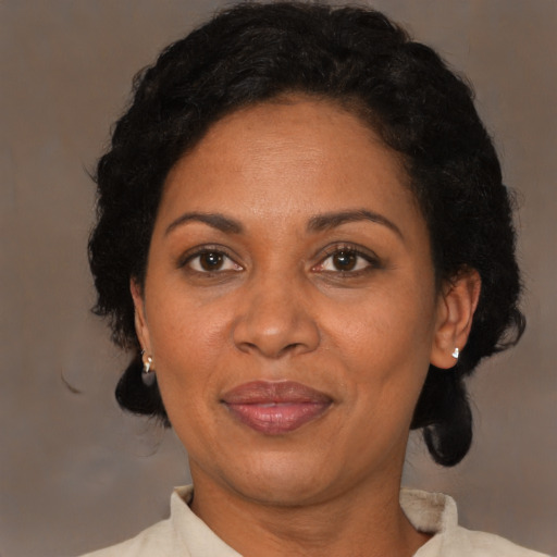 Joyful latino adult female with short  brown hair and brown eyes