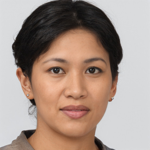 Joyful asian young-adult female with short  brown hair and brown eyes