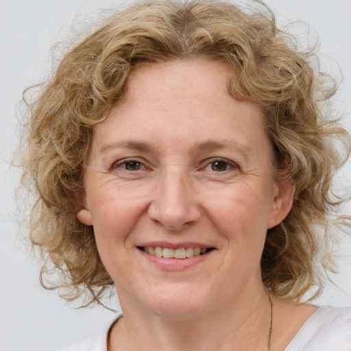 Joyful white adult female with medium  brown hair and blue eyes