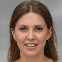 Joyful white young-adult female with long  brown hair and grey eyes