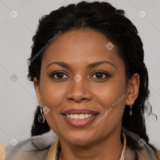 Joyful black adult female with long  brown hair and brown eyes