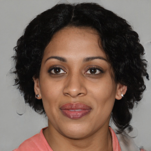 Joyful black adult female with medium  black hair and brown eyes