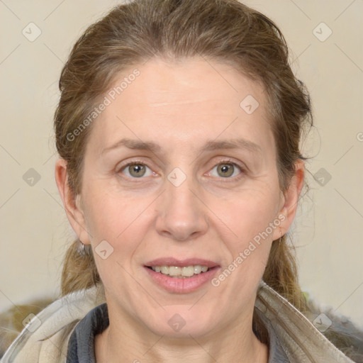 Joyful white adult female with medium  brown hair and grey eyes