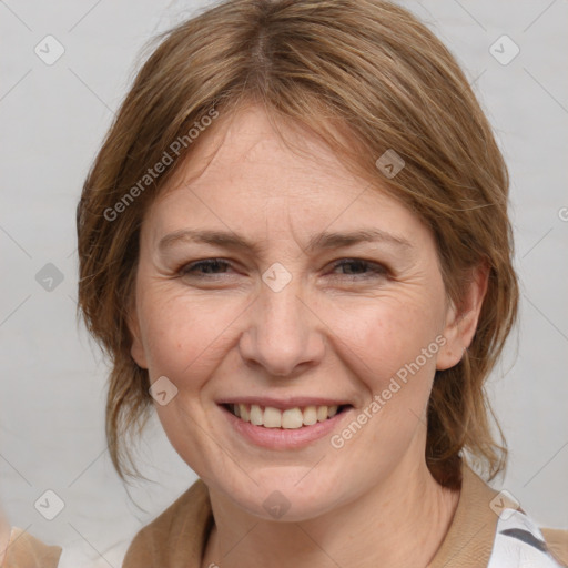 Joyful white adult female with medium  brown hair and blue eyes