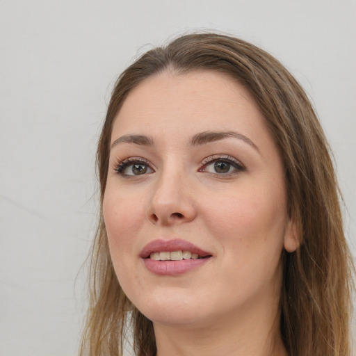 Joyful white young-adult female with long  brown hair and grey eyes