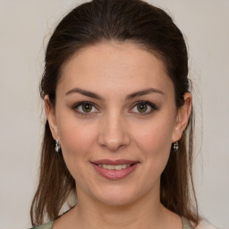 Joyful white young-adult female with medium  brown hair and grey eyes