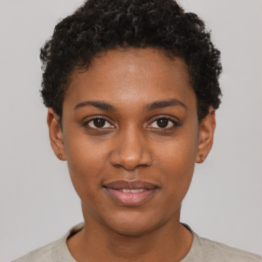 Joyful black young-adult female with short  brown hair and brown eyes