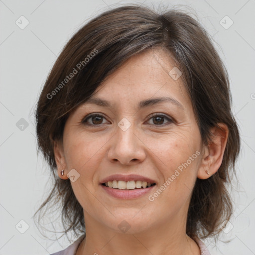 Joyful white adult female with medium  brown hair and brown eyes