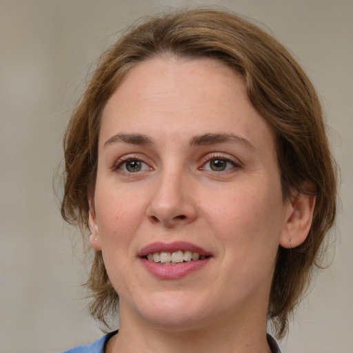 Joyful white young-adult female with medium  brown hair and green eyes