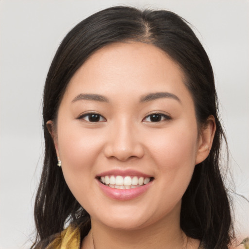 Joyful white young-adult female with long  brown hair and brown eyes