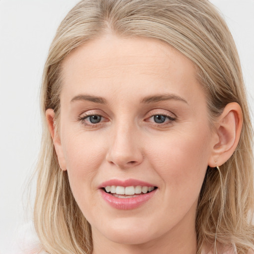 Joyful white young-adult female with long  brown hair and blue eyes