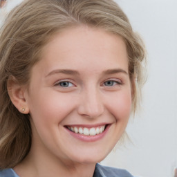 Joyful white young-adult female with medium  brown hair and blue eyes