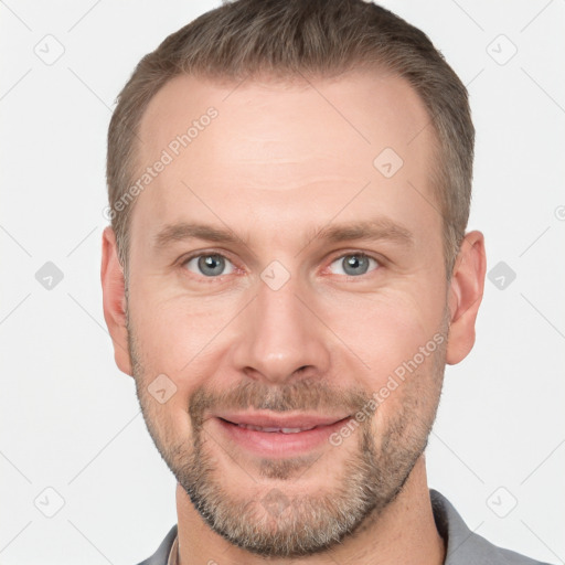 Joyful white adult male with short  brown hair and grey eyes