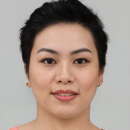 Joyful asian young-adult female with medium  brown hair and brown eyes