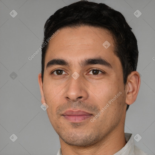 Joyful white young-adult male with short  black hair and brown eyes