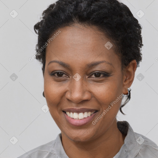 Joyful black adult female with short  black hair and brown eyes