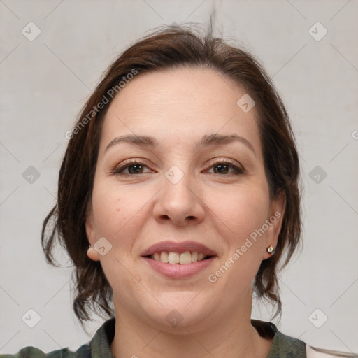 Joyful white adult female with medium  brown hair and grey eyes