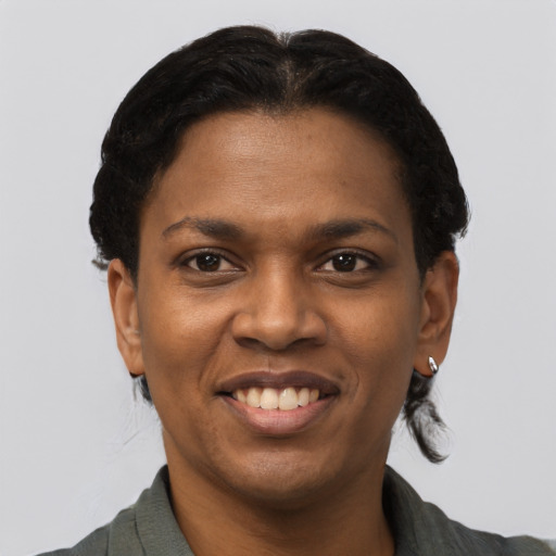 Joyful black young-adult female with short  brown hair and brown eyes