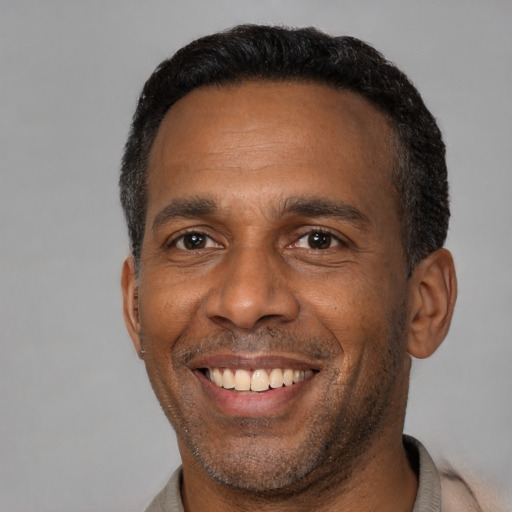 Joyful latino adult male with short  black hair and brown eyes