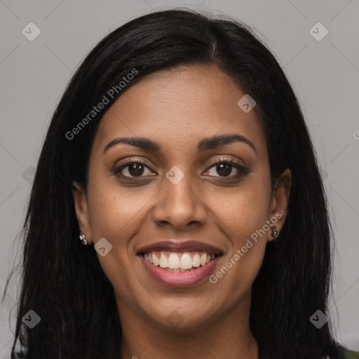 Joyful black young-adult female with long  brown hair and brown eyes