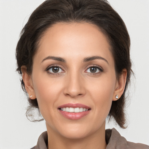 Joyful white young-adult female with medium  brown hair and brown eyes