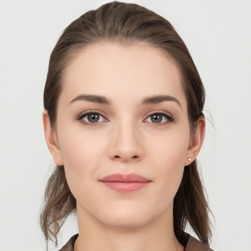 Joyful white young-adult female with long  brown hair and grey eyes