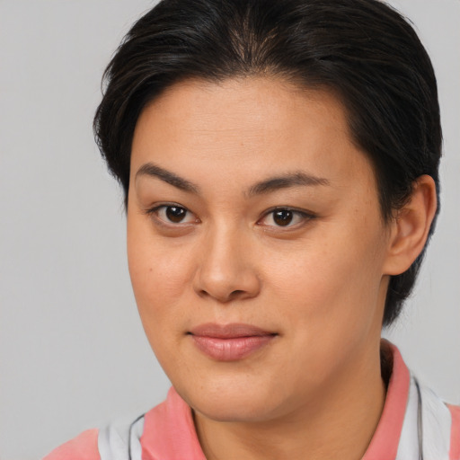 Joyful asian young-adult female with short  brown hair and brown eyes