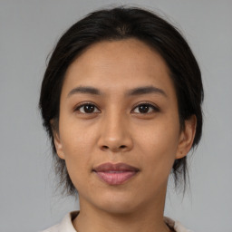 Joyful asian young-adult female with medium  brown hair and brown eyes