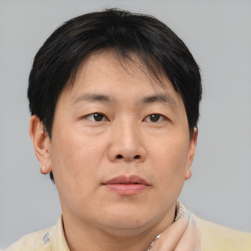 Neutral asian adult male with short  brown hair and brown eyes