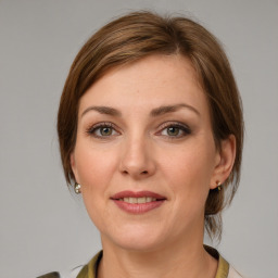 Joyful white young-adult female with medium  brown hair and green eyes